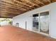 Covered patio featuring concrete flooring, wood ceilings, and sliding door access to the home at 13918 Raie Ave, Hudson, FL 34667