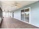 Spacious, screened patio features ceiling fans and sliding glass doors, perfect for entertaining and relaxation at 13918 Raie Ave, Hudson, FL 34667