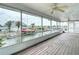 Enclosed outdoor porch boasts stunning water views and a ceiling fan at 13918 Raie Ave, Hudson, FL 34667