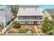 Exterior of home featuring a rear deck, patio, boat lift, lush lawn, and waterfront access at 13918 Raie Ave, Hudson, FL 34667