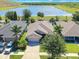 An aerial view showcases the home's well-kept lawn and desirable location near a lake at 14510 Haddon Mist Dr, Wimauma, FL 33598