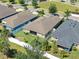 A detailed aerial shot displays the property's backyard, screened-in porch, and adjacent homes at 14510 Haddon Mist Dr, Wimauma, FL 33598