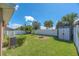 The backyard offers a fire pit, shed, privacy fence, and manicured landscaping at 14510 Haddon Mist Dr, Wimauma, FL 33598