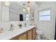Modern bathroom with double sinks, woven wood cabinets, stylish mirror, and contemporary fixtures at 1503 4Th St Sw, Largo, FL 33770