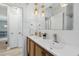 Bright bathroom features a double vanity with modern fixtures and stylish lighting at 1503 4Th St Sw, Largo, FL 33770