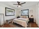 Cozy bedroom with natural light, ceiling fan, and a comfortable bed with stylish decor at 1503 4Th St Sw, Largo, FL 33770