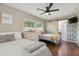 Inviting bedroom with wood floors, two beds, and a sliding barn door to the ensuite bathroom at 1503 4Th St Sw, Largo, FL 33770