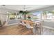 Sunlit dining room features a modern table with chairs, large windows and a decorative hammock at 1503 4Th St Sw, Largo, FL 33770