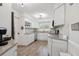 Bright kitchen with white cabinetry, stainless steel appliances, and stylish granite countertops at 1503 4Th St Sw, Largo, FL 33770