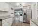 Spacious kitchen with stainless steel appliances, white cabinetry, and an open view to the dining area at 1503 4Th St Sw, Largo, FL 33770