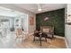 Bright living room with a greenery accent wall, modern lighting and a cozy seating arrangement at 1503 4Th St Sw, Largo, FL 33770