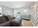 Comfortable living room featuring a cozy sofa, putting green, and natural light at 1503 4Th St Sw, Largo, FL 33770