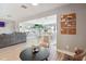 Open concept floor plan showcases the living room with modern furnishings and view of the dining area at 1503 4Th St Sw, Largo, FL 33770