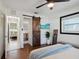 Sunlit primary bedroom features a sliding barn door, modern ceiling fan, and contemporary furnishings at 1503 4Th St Sw, Largo, FL 33770