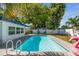 Sparkling pool surrounded by a backyard with a privacy fence and lush greenery at 1503 4Th St Sw, Largo, FL 33770
