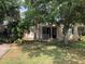 Charming single-story home featuring mature trees, a covered porch, and a well-maintained lawn at 1508 S Clark Ave, Tampa, FL 33629