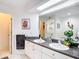 Bathroom with double sink vanity, granite counters, and a large mirror at 1628 Lullwater Ln, Lutz, FL 33549