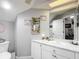 Bathroom vanity with ornate mirror, under cabinet storage and granite counters at 1628 Lullwater Ln, Lutz, FL 33549