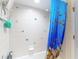 Bathtub and shower with a charming blue fish themed shower curtain at 1628 Lullwater Ln, Lutz, FL 33549