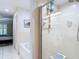 Bathroom featuring an accessible glass-enclosed shower, and access to a bath at 1628 Lullwater Ln, Lutz, FL 33549