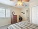 Bedroom with a large window, wicker dresser, and overhead ceiling fan at 1628 Lullwater Ln, Lutz, FL 33549