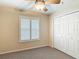 Bedroom with a large closet and shuttered window provides ample storage at 1628 Lullwater Ln, Lutz, FL 33549