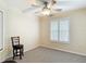 Bedroom featuring neutral walls, a ceiling fan, and a shuttered window at 1628 Lullwater Ln, Lutz, FL 33549