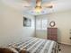 Bedroom showcasing a shuttered window, wicker dresser, and ceiling fan at 1628 Lullwater Ln, Lutz, FL 33549