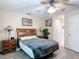 Comfortable bedroom with ceiling fan and view into the ensuite bathroom at 1628 Lullwater Ln, Lutz, FL 33549