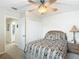 Cozy bedroom featuring a ceiling fan, closet, and ensuite bathroom access at 1628 Lullwater Ln, Lutz, FL 33549