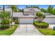 Charming two-story townhouse with a well-manicured lawn and attached two-car garage at 1628 Lullwater Ln, Lutz, FL 33549