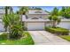 Charming two-story townhouse with a well-manicured lawn and attached two-car garage at 1628 Lullwater Ln, Lutz, FL 33549