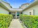 Pathway leading to the house through a lush green privacy hedge at 1628 Lullwater Ln, Lutz, FL 33549