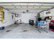 Spacious garage with concrete floor, storage cabinets, and plenty of room for parking and storage at 1628 Lullwater Ln, Lutz, FL 33549