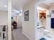 Hallway view with a half bathroom featuring a vanity and tiled flooring at 1628 Lullwater Ln, Lutz, FL 33549
