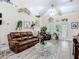 Bright living room features wood-look flooring, a ceiling fan, and unique fish-themed decorations at 1628 Lullwater Ln, Lutz, FL 33549
