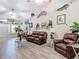 Bright and airy living room features wood-look floors, ceiling fans and fish decor at 1628 Lullwater Ln, Lutz, FL 33549