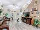 Bright open floor plan living room boasts vaulted ceiling, wood-look floors and fish decor at 1628 Lullwater Ln, Lutz, FL 33549