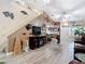 Spacious living room with wood-look flooring, staircase, and unique marine-themed decor at 1628 Lullwater Ln, Lutz, FL 33549