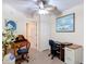 Home office features natural light, and neutral colors with desk and shelving at 1628 Lullwater Ln, Lutz, FL 33549