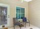 Cozy patio features neutral siding, tile floors, and comfortable seating with a lovely backyard view at 1628 Lullwater Ln, Lutz, FL 33549