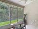 This inviting screened porch features tile flooring, ceiling fan, and view of the green backyard at 1628 Lullwater Ln, Lutz, FL 33549