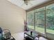 Relaxing screened porch features tile flooring, ceiling fan, and views of the backyard and mature trees at 1628 Lullwater Ln, Lutz, FL 33549