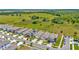 Aerial shot of a suburban street with homes and cars on a sunny day at 16892 Delia St, Wimauma, FL 33598