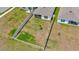 Aerial view of a home's fenced-in backyard surrounded by green lawns and other houses at 16892 Delia St, Wimauma, FL 33598