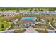 An aerial shot of a community pool, with walking path, playground and many homes at 16892 Delia St, Wimauma, FL 33598