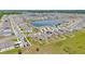 Aerial view of homes surrounding a large lake with a community pool at 16892 Delia St, Wimauma, FL 33598