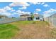 View of a spacious, partially-shaded backyard with a white fence surrounding the perimeter at 16892 Delia St, Wimauma, FL 33598