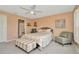 Comfortable bedroom with neutral walls, a ceiling fan, upholstered bedframe, and coordinated furnishings at 16892 Delia St, Wimauma, FL 33598