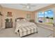 Cozy bedroom featuring a ceiling fan, window view, complemented by stylish furnishings and decor at 16892 Delia St, Wimauma, FL 33598